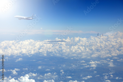 Samolot pasażerski odrzutowy nad chmurami w promieniach słońca.