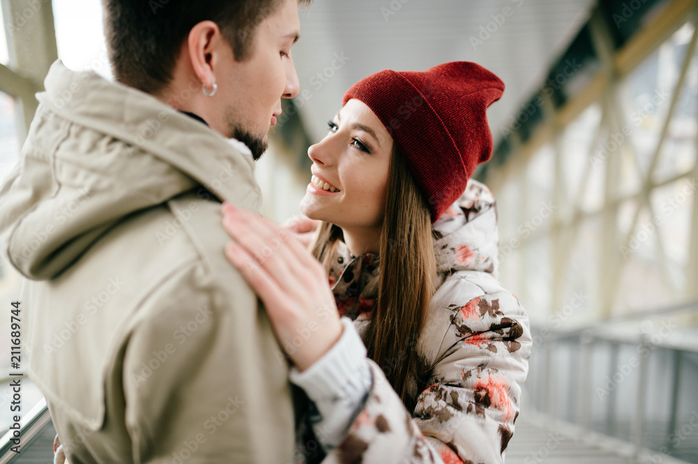 Lifestyle people. Young happy lovers embracing on meeting. Romantic pair of stylish cheerful hipsters hug. Girl in love. Happiness of loving youth couple. Emotional portrait of beautiful woman face.