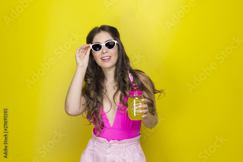  girl with long hair smiling with glasses drinking juice