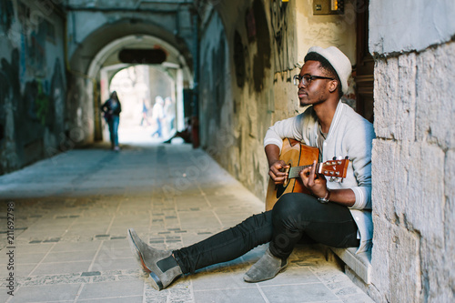 Photography African musician playing guitar in the city