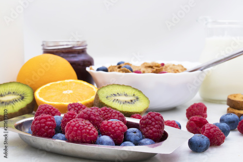 fresh fruit in the foreground with cereals and breakfast in the background, healthy food