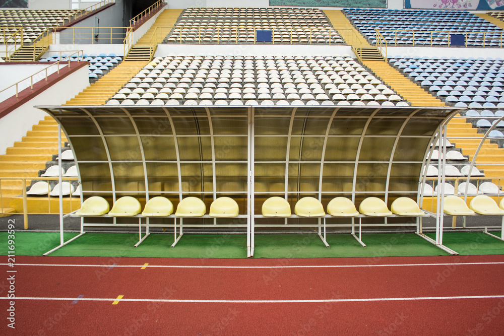 Obraz premium Empty bench football stadium spare sport concept near tribune and running road