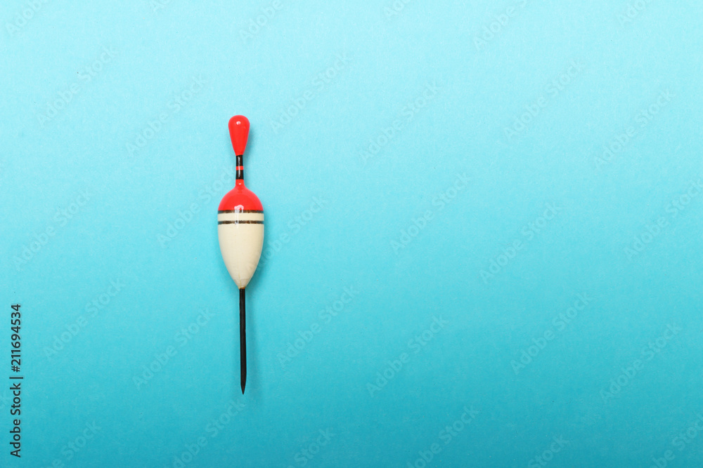 Homemade bobber on blue background. Picture with space for your text. Homemade bobber on blue background. Picture with space for your text.