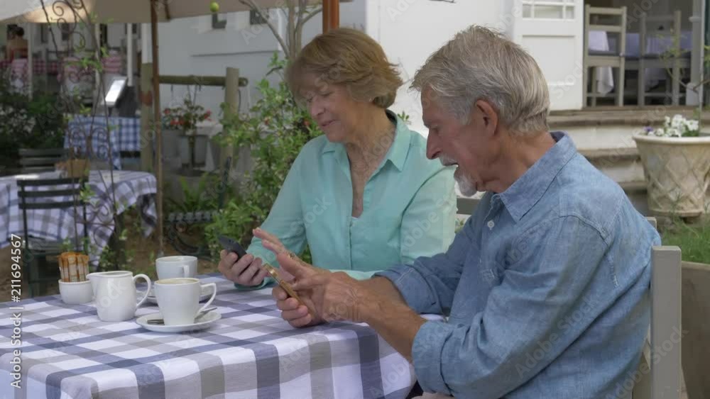 Senior couple sitting together in a cafe Senior couple sitting together in a cafe