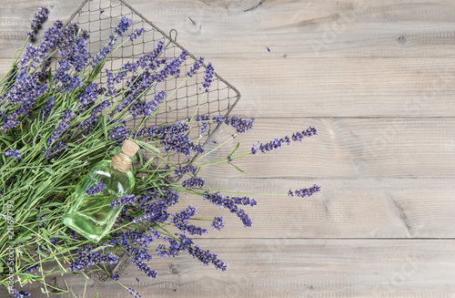 Fototapeta Naklejka Na Ścianę i Meble -  Lavender oil fresh flowers rustic wooden background