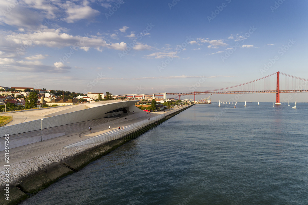 Aerial view of the city of Lisbon with Tagus River and the 25 of April Bridge on the background; Concept for travel in Portugal and visit Lisbon