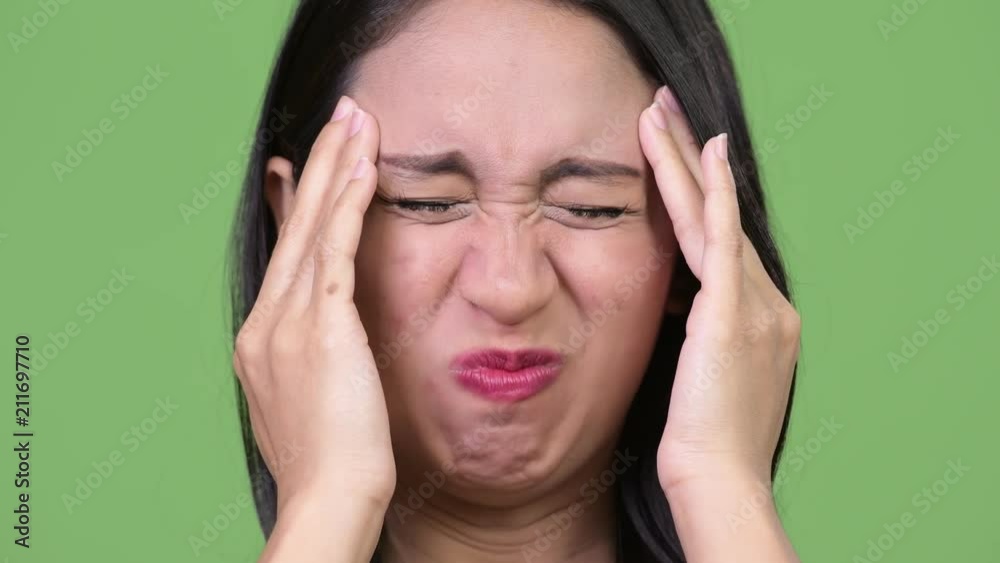 Young beautiful Asian businesswoman having headache Young beautiful Asian businesswoman having headache
