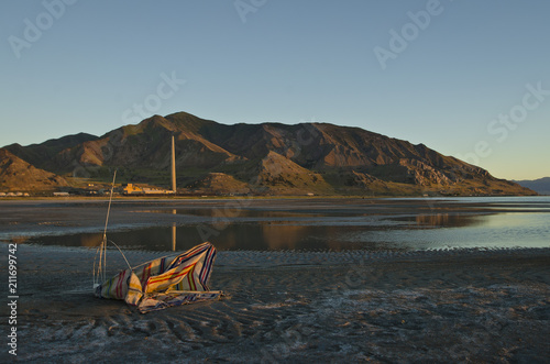 The broken down beach chair on the wasteland floor of the great salt lake.  photo