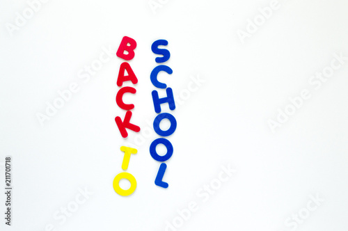 colorful foam letters spelling the words Back to School in vertical rows isolated on white
