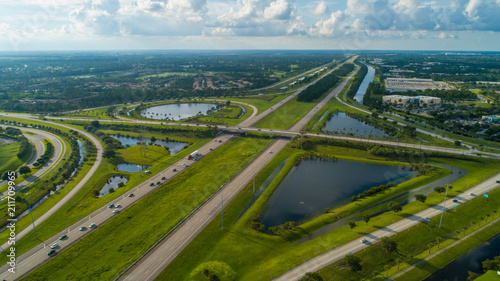 Aerial highway interchange with green grass landscape