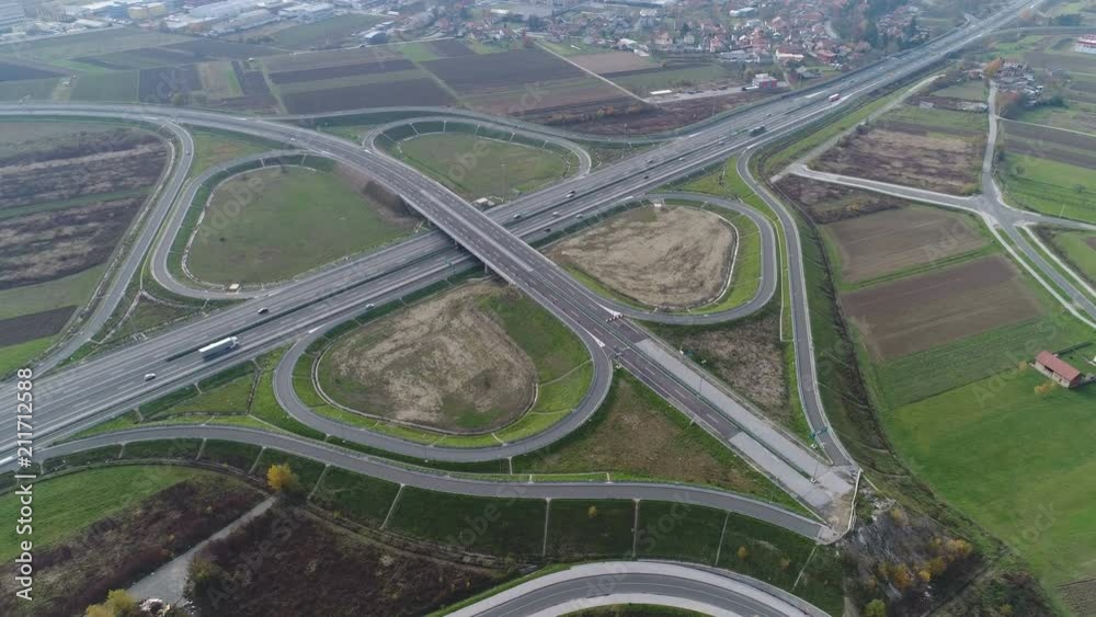 High angle drone shot of sparse traffic driving over modern intersection near Zagreb, Croatia