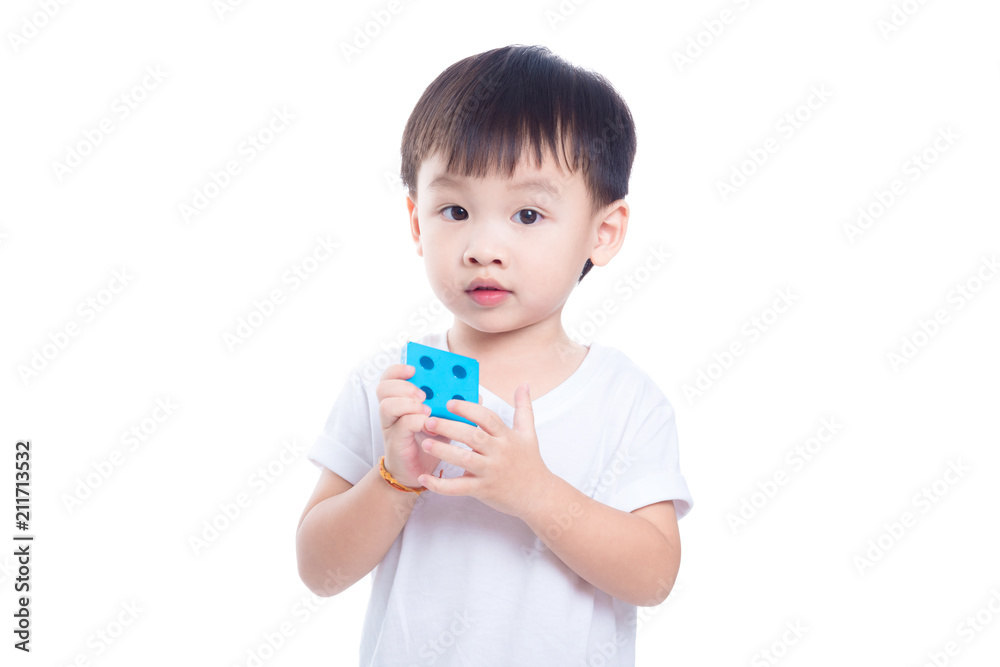 Little asian boy playing toy and looking at camera over white background Little asian boy playing toy and looking at camera over white background