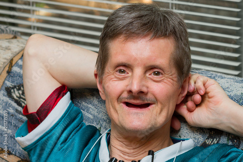 Down Syndrome Man No Teeth Leaning Back Smiling photo
