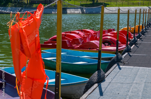 resort pier with life jackets for boats and catamarans on the lake