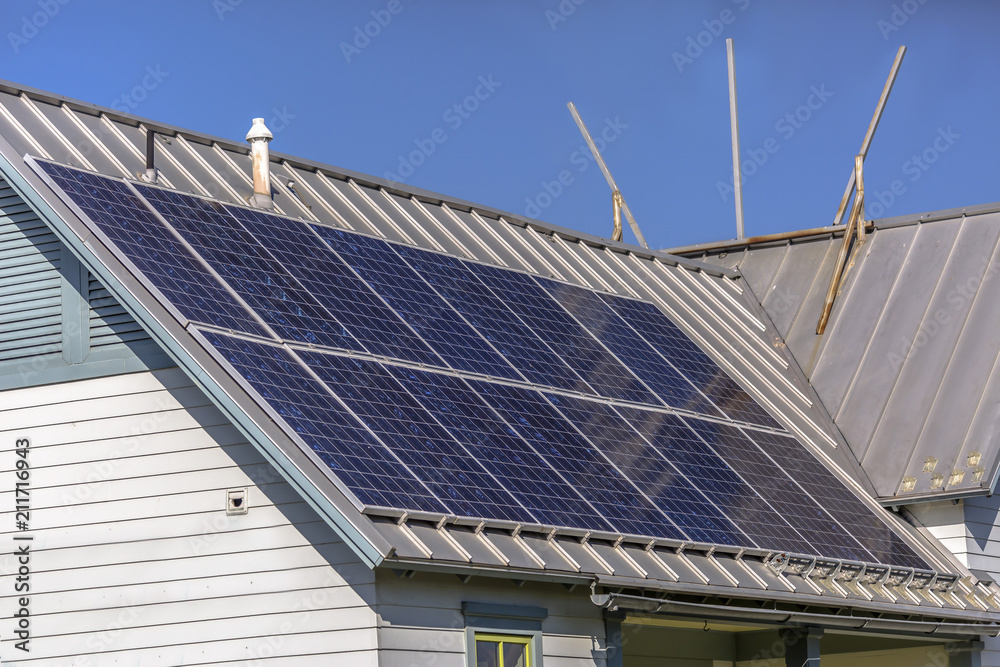 Fototapeta premium Solar panels on rooftop on a sunny day