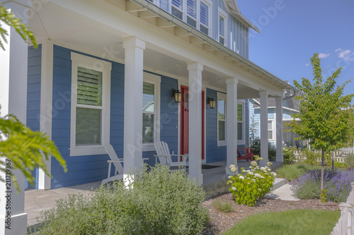 White pillars with red door on a home entry