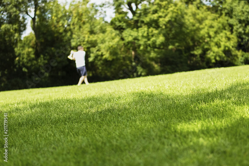 Wallpaper Mural Outline man playing ball and bat in park on green grass. English outdoor activity game Torontodigital.ca