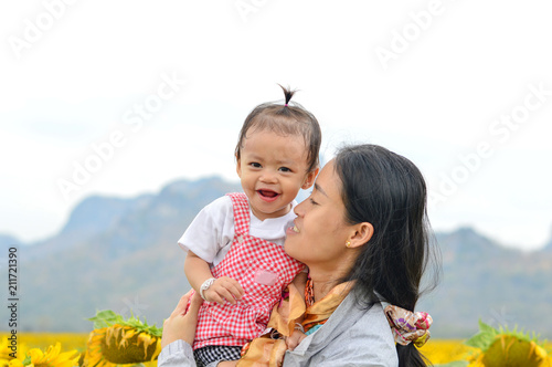 Mother and children are happy in sunflower farm