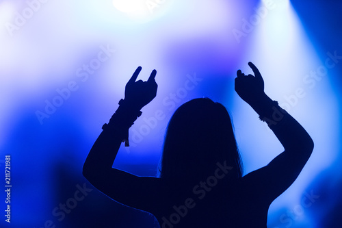 Girl Raising Hands at a Concert