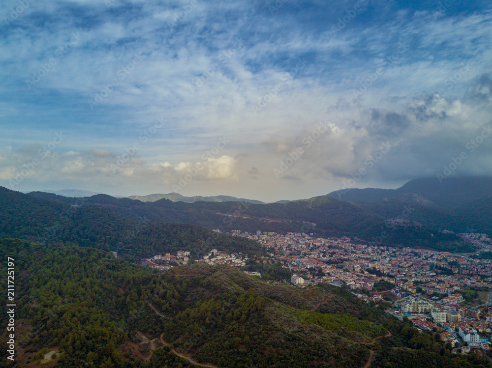 Amaizing view of Marmaris bay in cloudy day with the sun shyning through the clouds, city in the valley