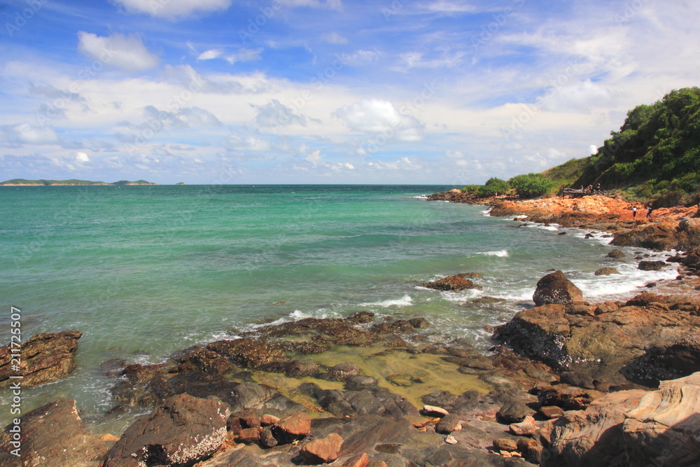 Rocks and calm sea with islands on the horizon and white clouds,Blue sky for background.At Khao Laem Ya - Mu Ko Samet National Park