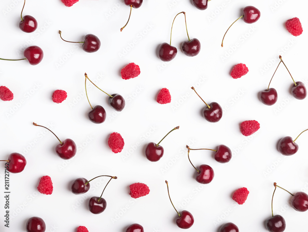 Ripe raspberries and cherries on the white background. Ripe raspberries and cherries on the white background.