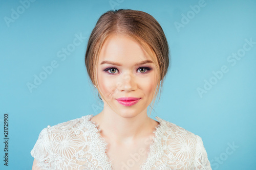 portrait of a young beautiful girl on a blue background photo