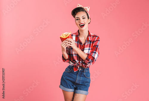 Happy young pin-up woman isolated over pink background