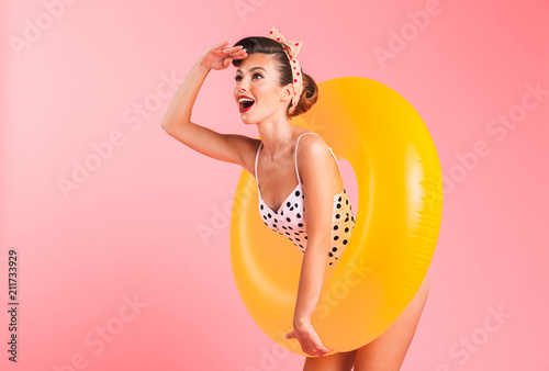 Obraz na plátně Gorgeous young pin-up woman in swimwear with inflatable ring