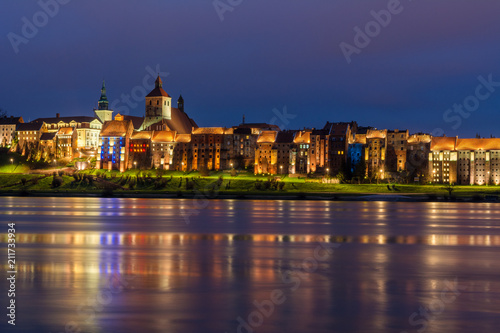 A view of Grudziadz at night reflected in Vistula river, Poland. Europe.