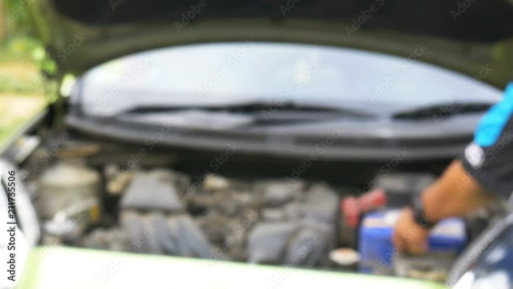 Defocus of technicial replacing car battery. Defocus of technicial replacing car battery.