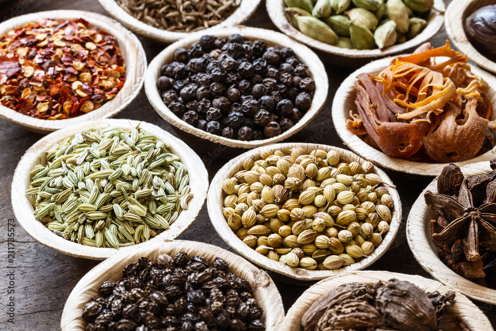 Group of indian spices in coconut bowls on wooden background Group of indian spices in coconut bowls on wooden background