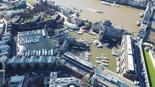 Aerial drone bird's eye view of famous St Katharine Docks Marina and iconic skyline in City of London, United Kingdom © aerial-drone