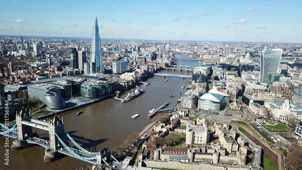 Aerial drone bird's eye view of iconic Tower Bridge, the Shard and skyline in City of London, United Kingdom