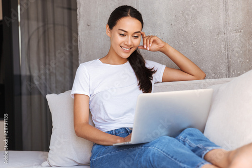 Attractive young asian woman using laptop computer photo