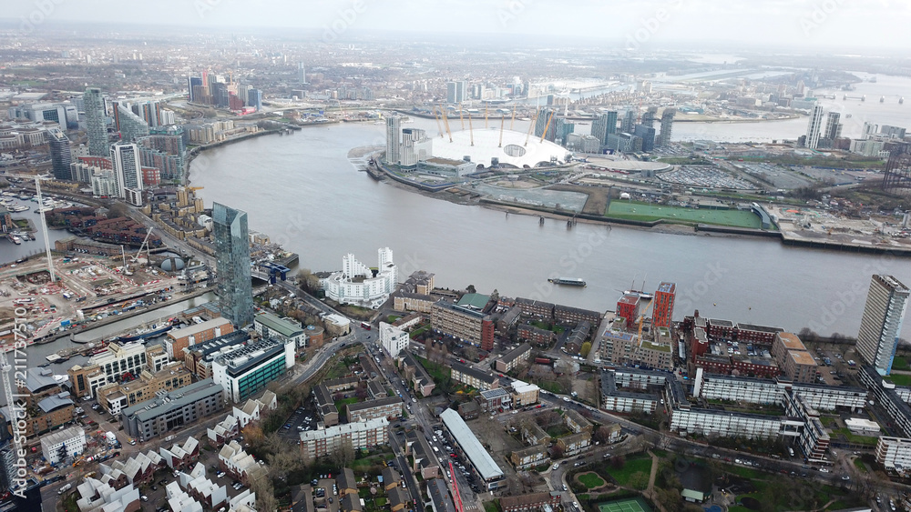 Obraz premium Aerial bird's eye view photo taken by drone of famous Docklands and Canary Wharf skyscraper complex, Isle of Dogs, London, United Kingdom