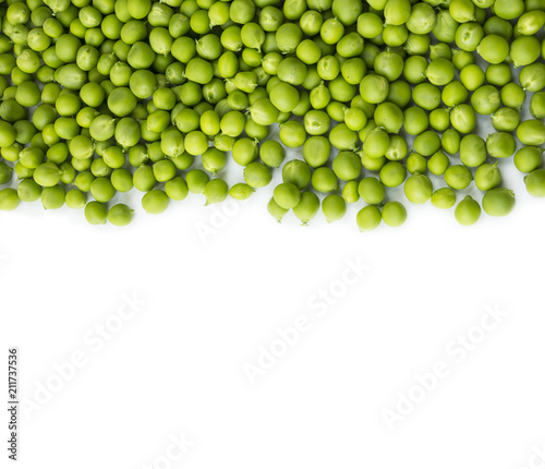 Green peas on a white background. Green peas at border of image with copy space for text.