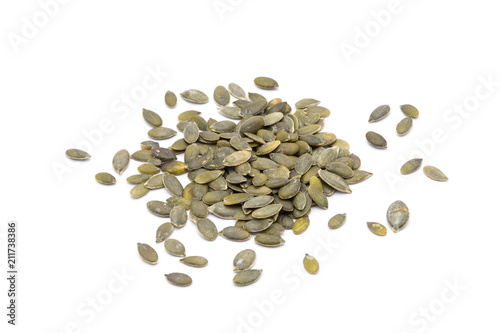 Heap of pumpkin seeds in natural condition, isolated on white background