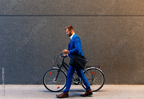 Young businessman going to work with his bicycle. photo