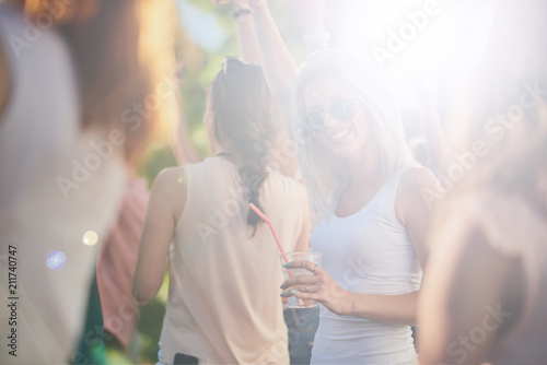 Group of people dancing and having a good time at the outdoor party/music festival 