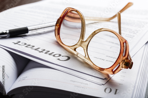 Close up shot of Eyeglasses on contract document papers business concept