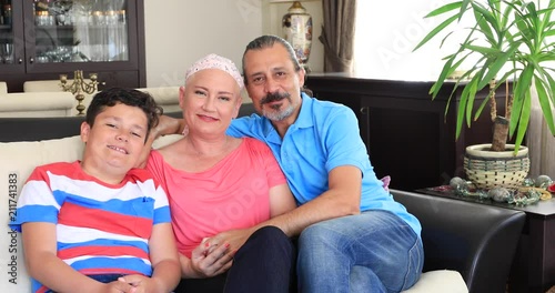 Portrait of a happy sick woman fight with cancer with family's help