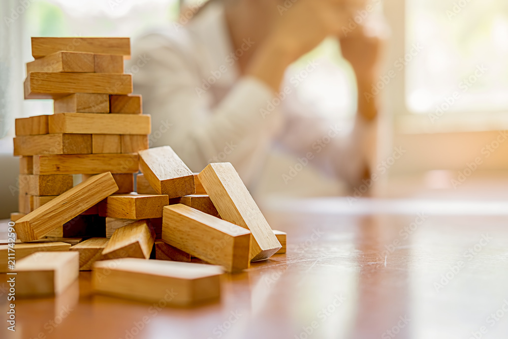 Problem Solving Business can't stop effect of dominoes continuous toppled with business team feeling sad and stress in office background. Failure Business Concept. Problem Solving Business can't stop effect of dominoes continuous toppled with business team feeling sad and stress in office background. Failure Business Concept.