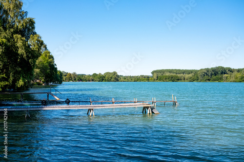 Jetty at Lake Pilsensee in Bavaria, Germany on a sunny day photo