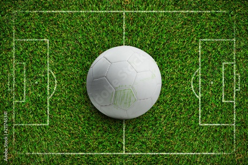 Composite image of white leather football with grass stains