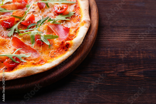 Restaurant, food delivery, pizzeria menu concept. Appetizing ham pizza with arugula flat lay with copy space. Delicious classical recipe, traditional Italian snack