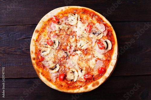 Pizza with cherry tomatoes, ham and mushrooms, traditional Italian recipe, delicious mediterranean meals. Food delivery, restaurant, pizzeria menu concept