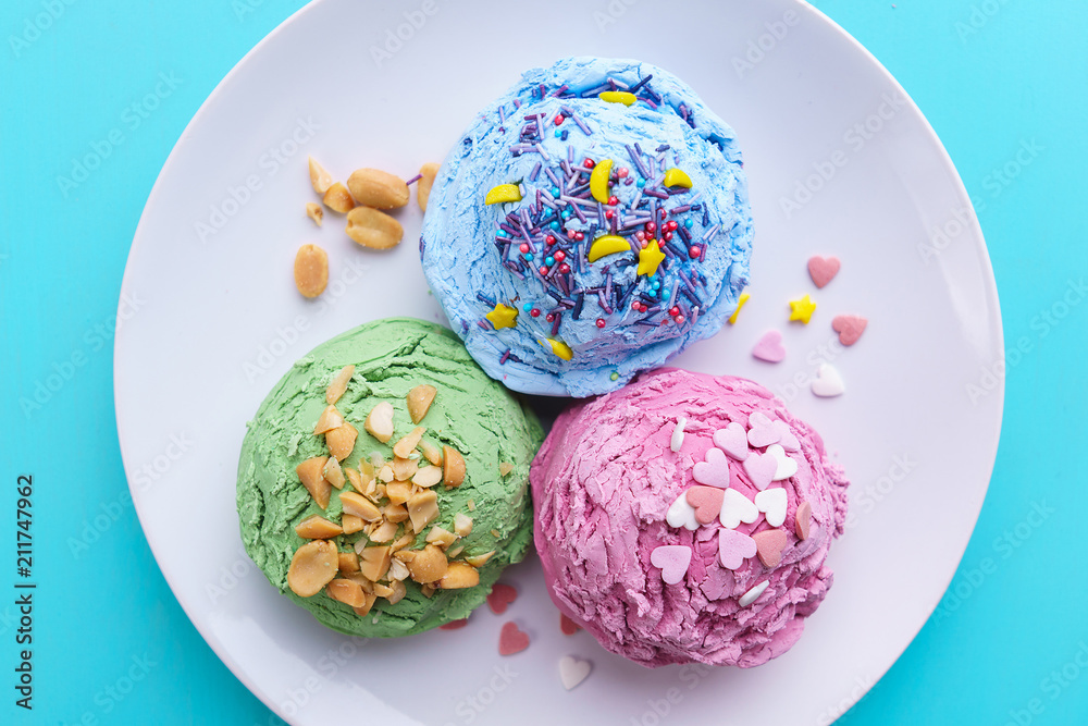 Assorted ice cream scoops on plate, flat lay. food background, summer seasonal sweets, cold refreshing dessert close up. Assorted ice cream scoops on plate, flat lay. food background, summer seasonal sweets, cold refreshing dessert close up.