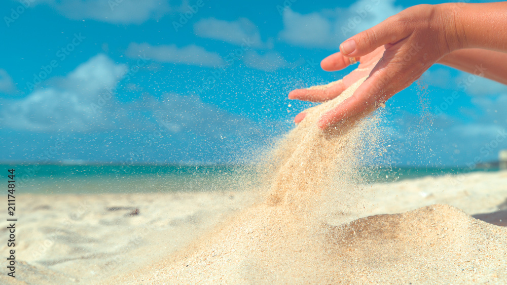 COPY SPACE: Small grains of sand slowly slip out of unrecognizable female hand. - obrazy, fototapety, plakaty 