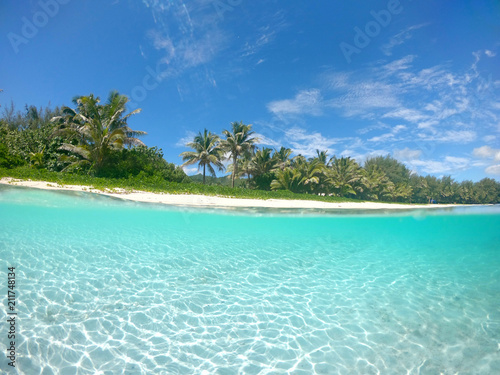 HALF UNDERWATER: Cool shot of empty tropical beach in the tourist off season © helivideo